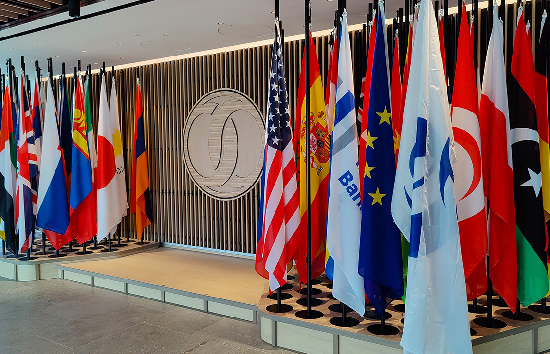 numerous international flags next to a podium stage